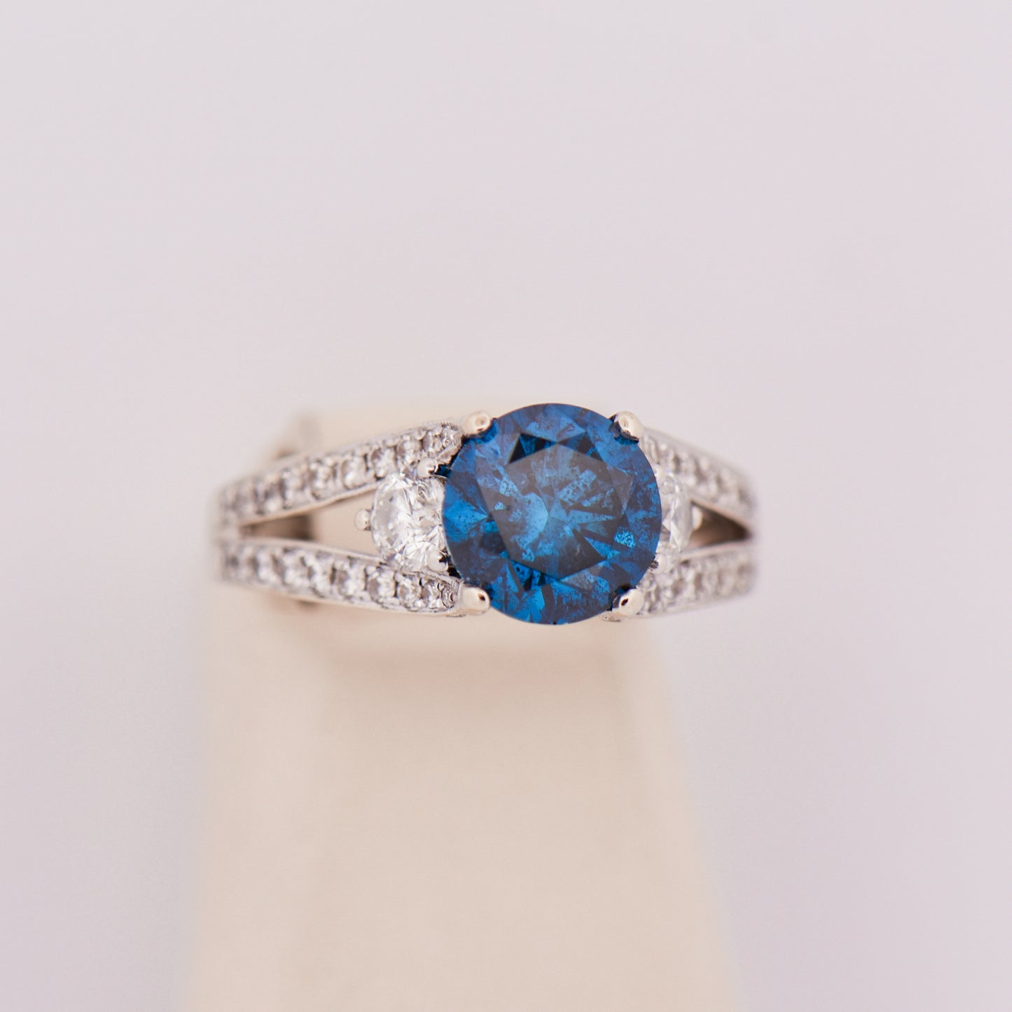 Round Blue Diamond Three-Stone Ring in White Gold
