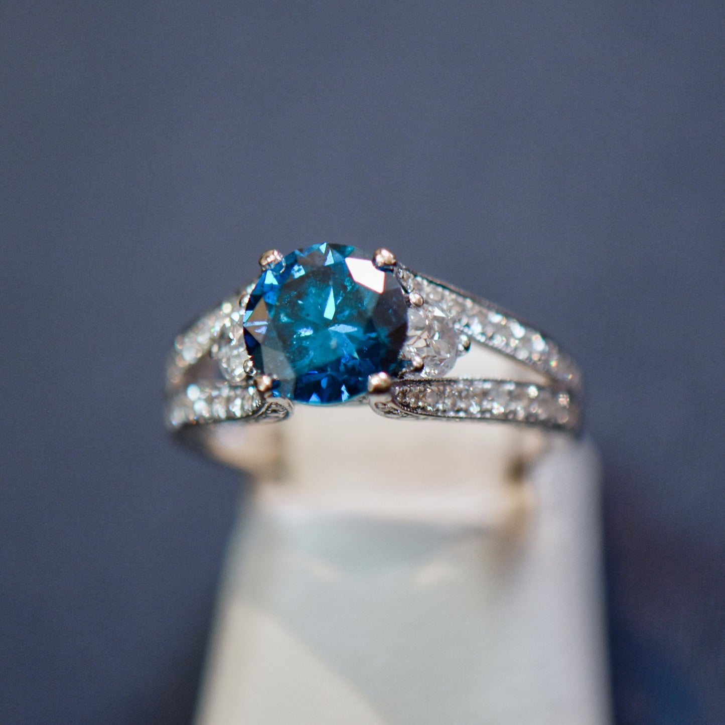 Round Blue Diamond Three-Stone Ring in White Gold