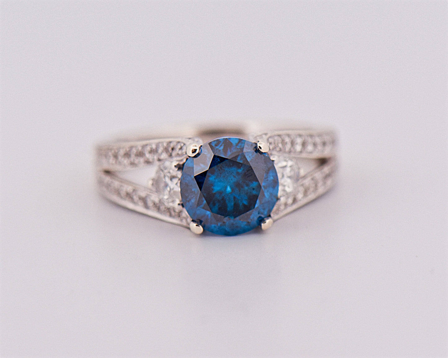 Round Blue Diamond Three-Stone Ring in White Gold