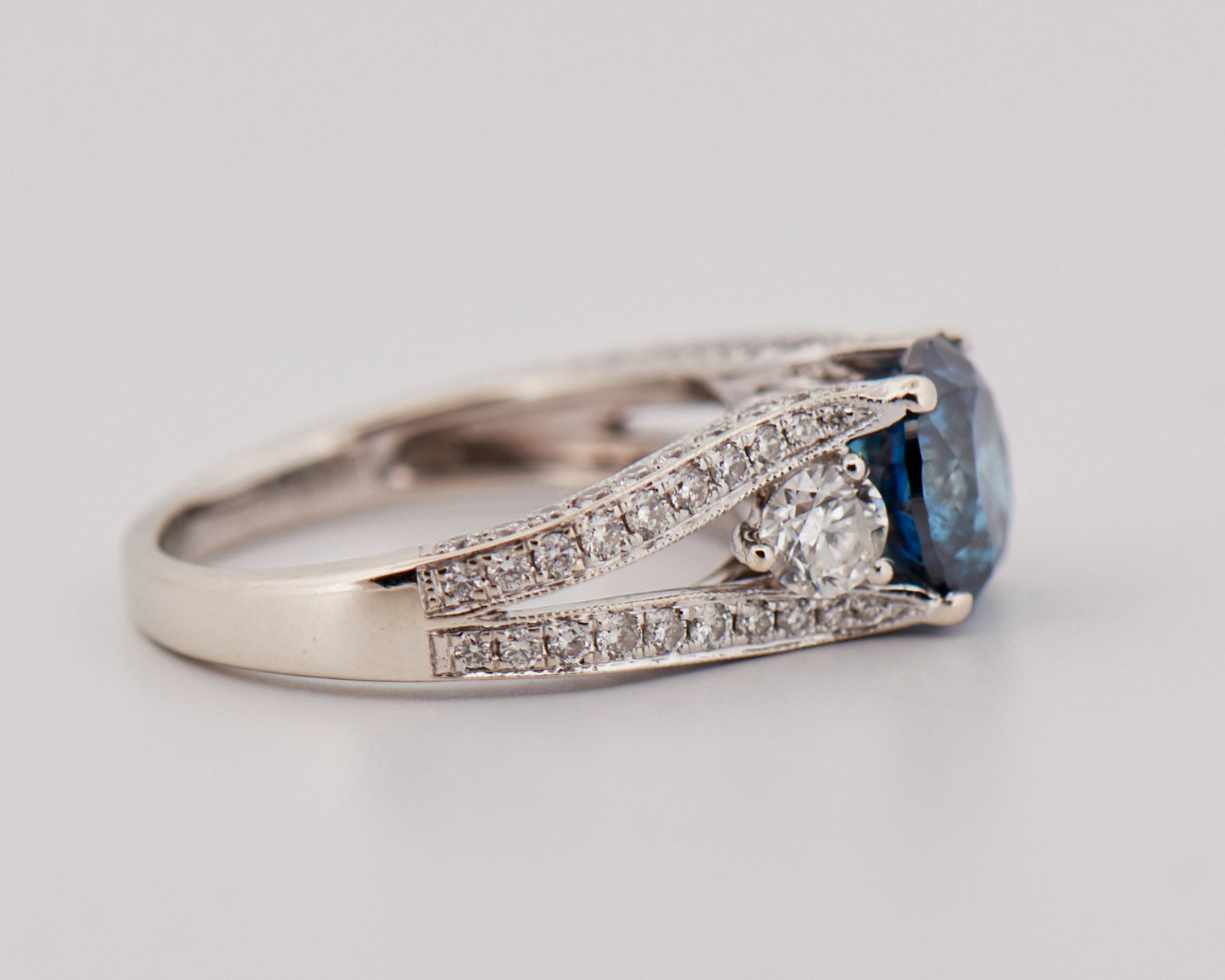 Round Blue Diamond Three-Stone Ring in White Gold