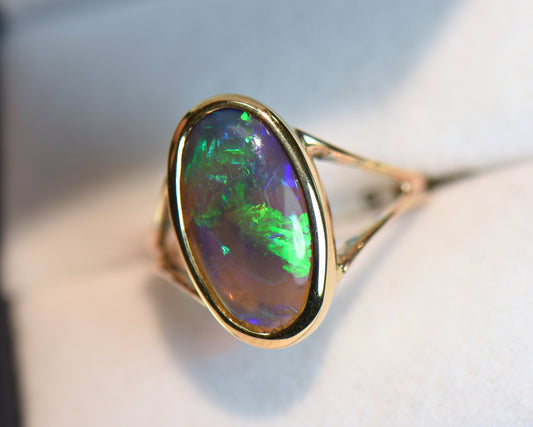 Black Crystal Opal Solitaire Ring in Yellow Gold Bezel