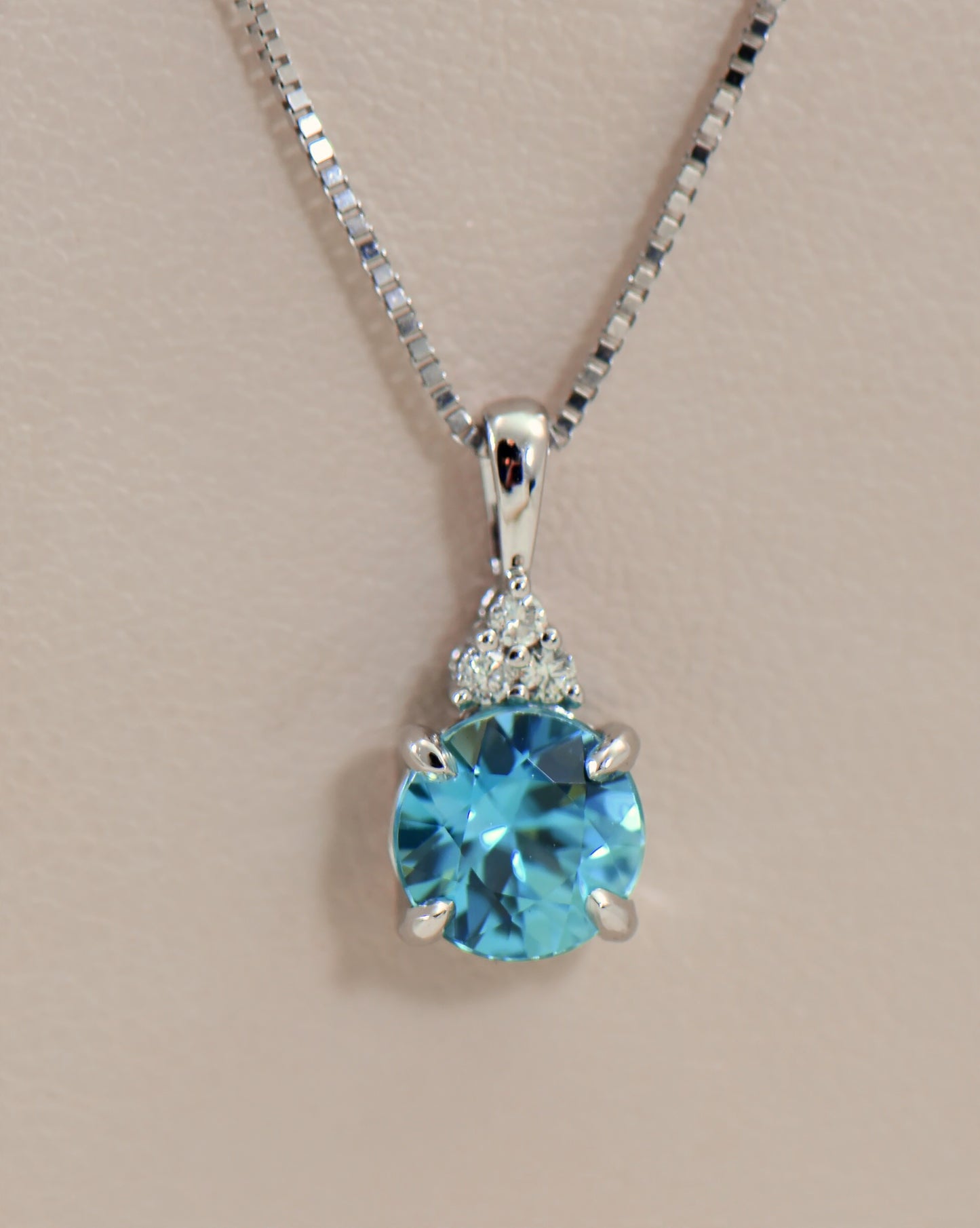 Round Blue Zircon and Diamond Pendant in White Gold