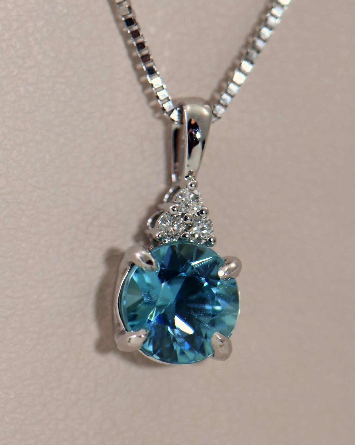 Round Blue Zircon and Diamond Pendant in White Gold
