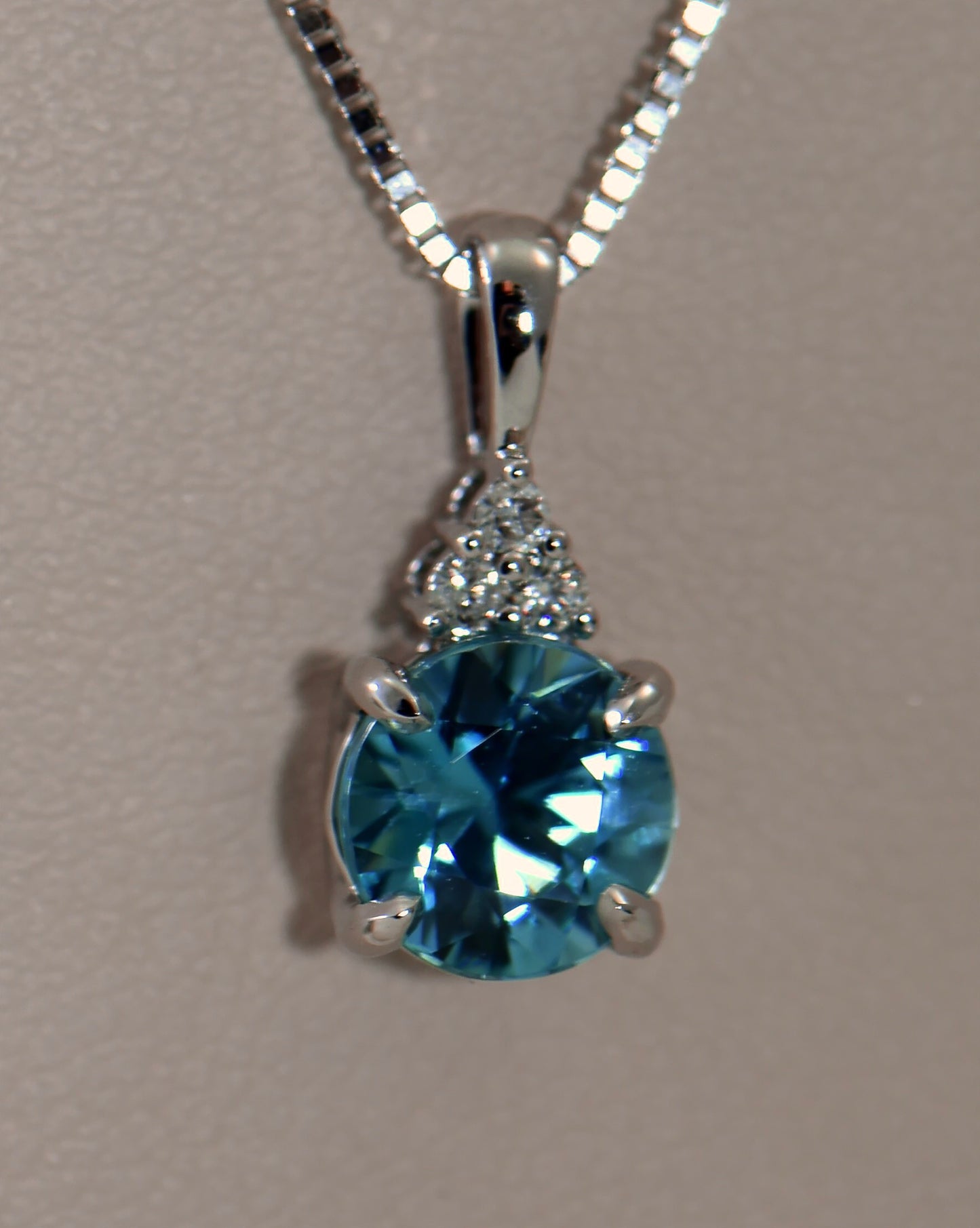 Round Blue Zircon and Diamond Pendant in White Gold