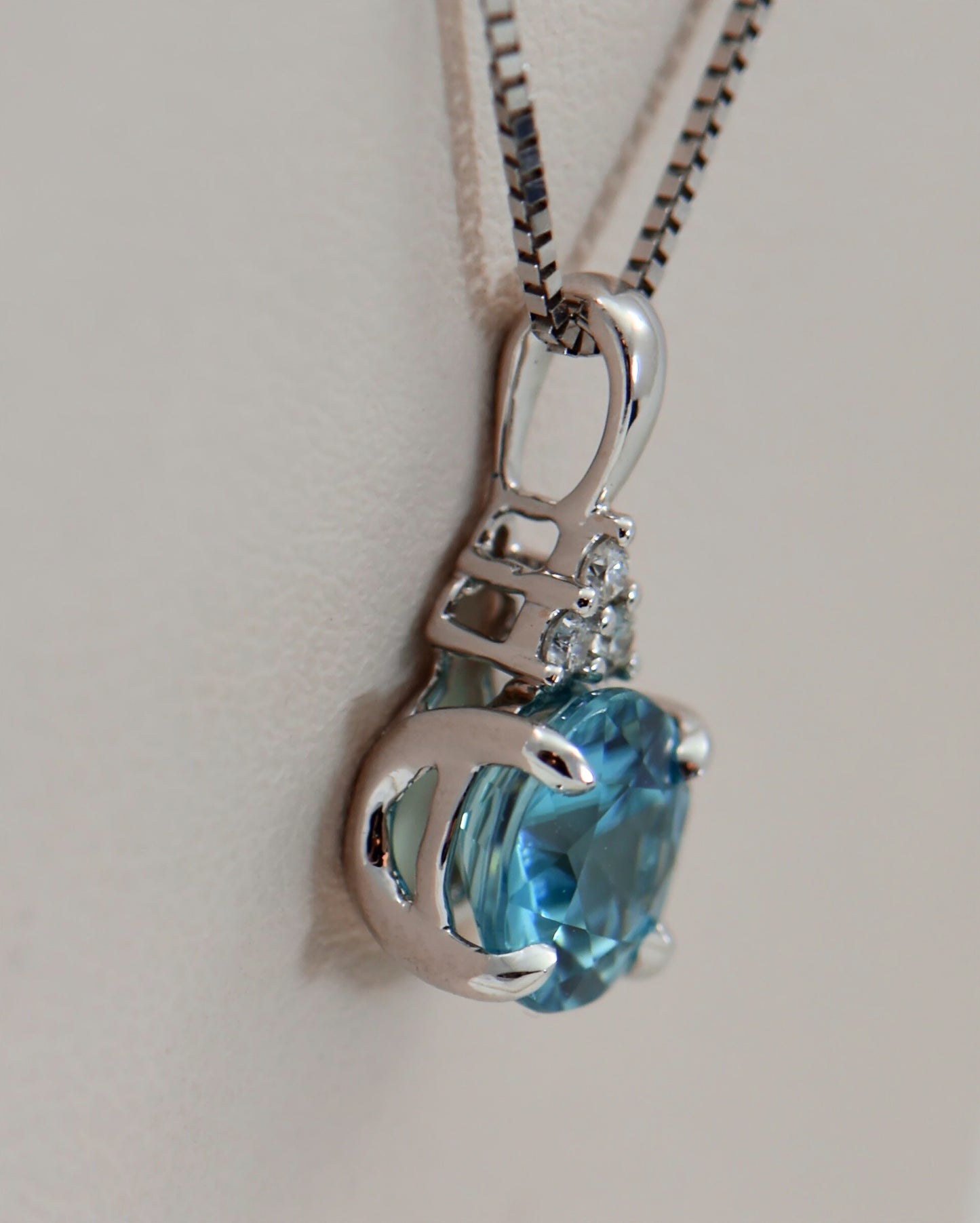 Round Blue Zircon and Diamond Pendant in White Gold