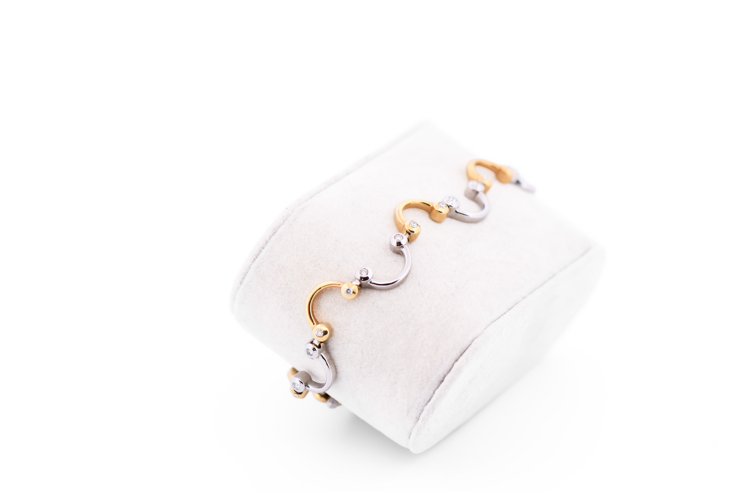 Swirling Two-Tone Gold Link Bracelet with Bezel Set Diamond Accents