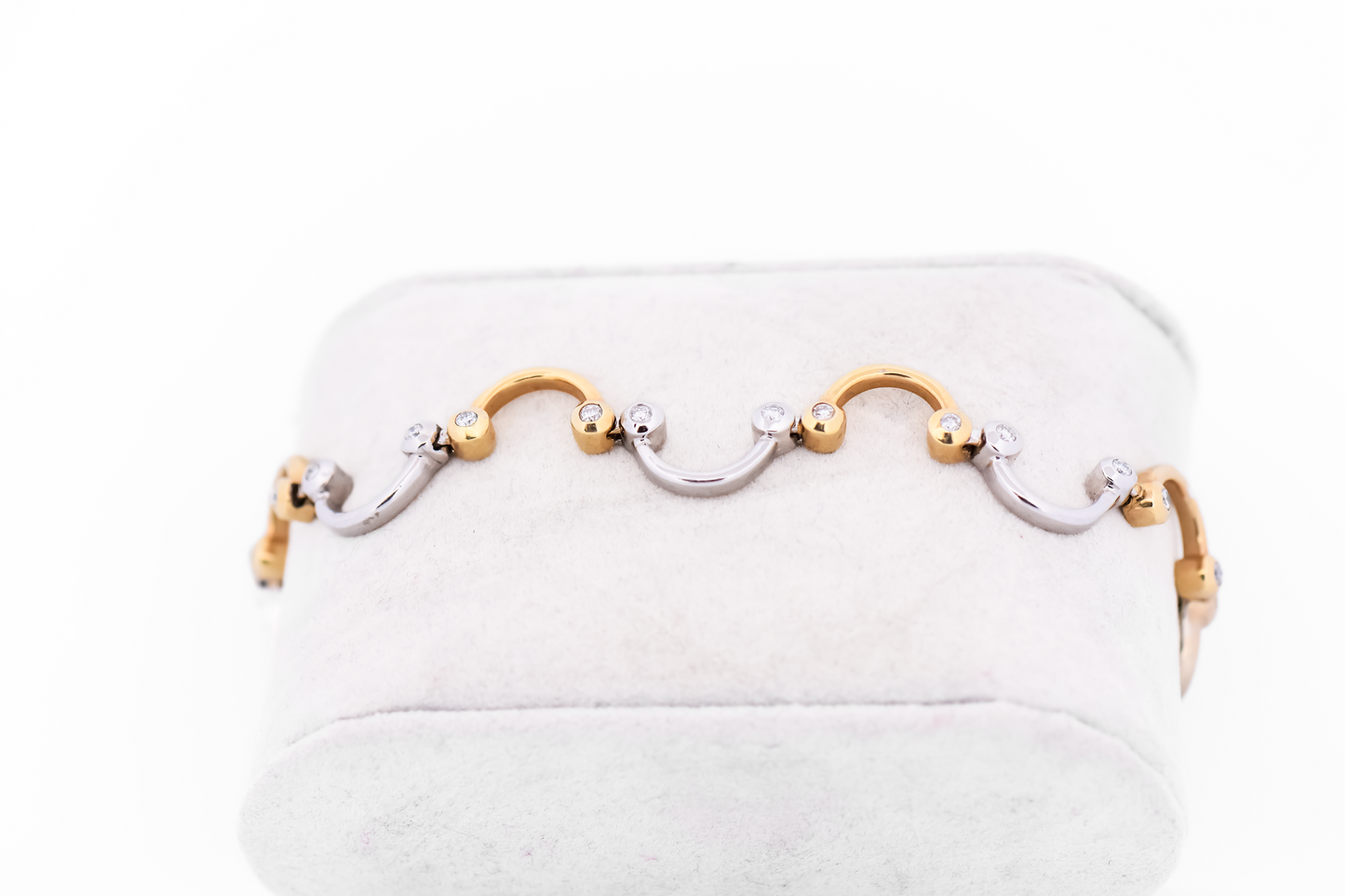 Swirling Two-Tone Gold Link Bracelet with Bezel Set Diamond Accents